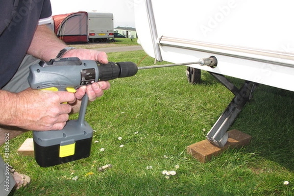 Obraz Caravan corner stays with power tool.