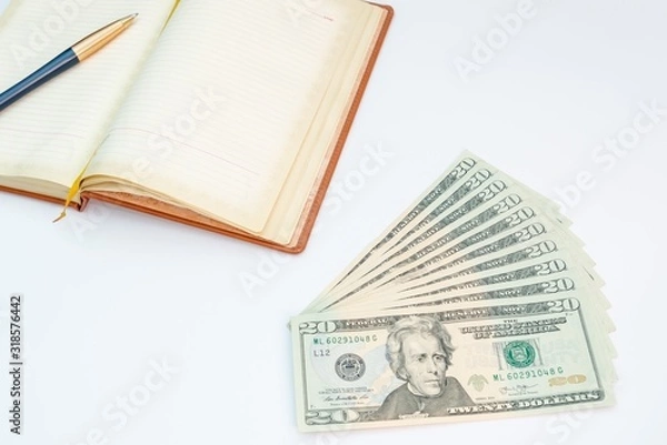 Fototapeta Money, notebook and pen with white background. Isolated