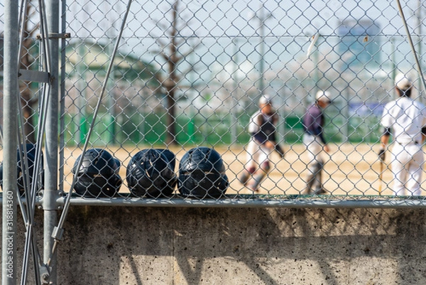 Fototapeta 野球を練習する少年とヘルメット