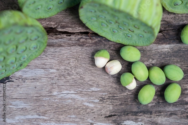 Fototapeta Lotus seed or lotus nut. The traditional Chinese and Indian medicine. Good for healty and can eat both fresh and dried seed as a snack or cooking as a food. Shooting on vintage wood surface table.