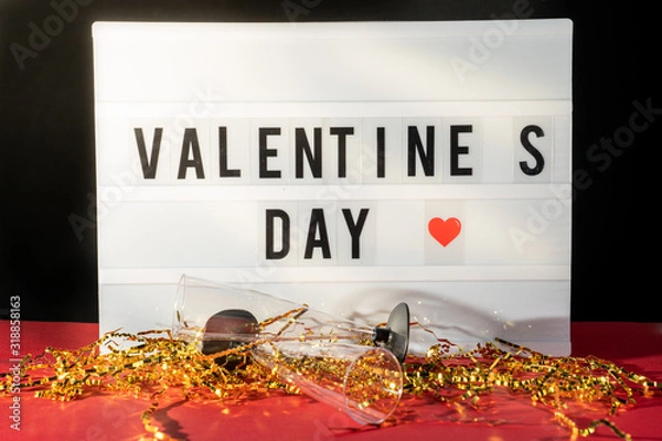 Obraz Bright Valentine's Day sign, champagne glasses and gold confetti.