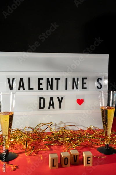 Obraz Bright Valentine's Day sign, champagne glasses and gold confetti.