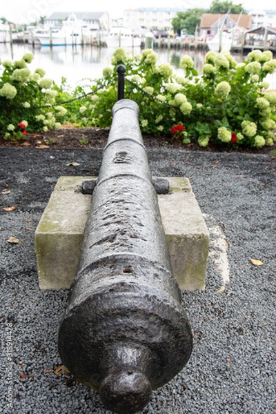 Obraz Vertical view of historic cannon at 1812 Memorial Park in Lewes Delaware with canal in background