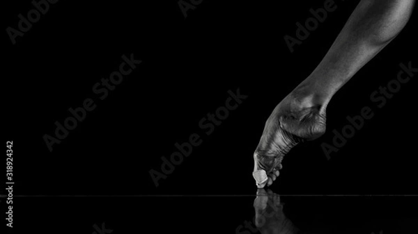 Fototapeta Ballet Dancer Point and Leg , intentionally shoot at High ISO to give grainy and dramatic feel, selective noise reduction applied, Low Key, Black and White Studio Shot