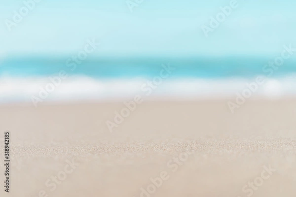 Fototapeta Blur tropical beach with bokeh sun light wave abstract background.
