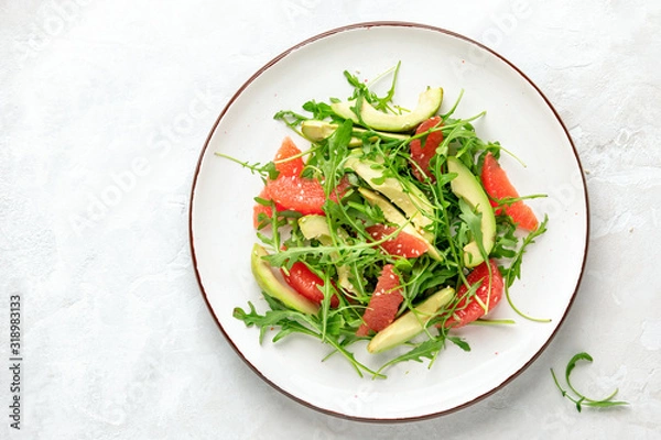 Fototapeta Detox grapefruit and arugula salad, top down view