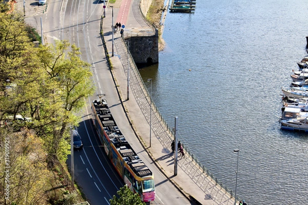 Obraz Overhead view of Prague tram on road near river