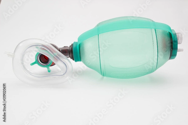 Fototapeta Green AMBU bag with respiratory support mask isolated at the white background