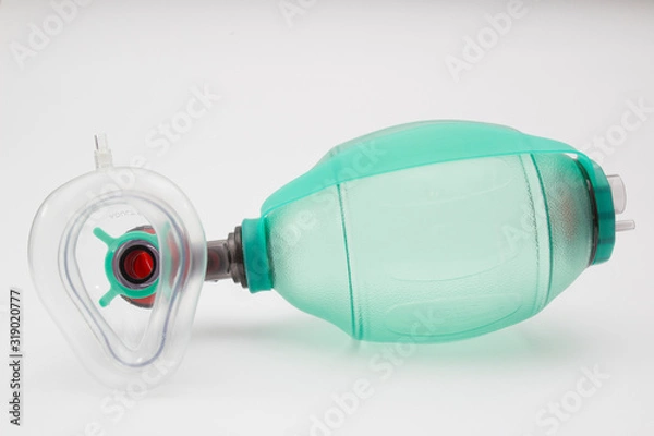 Fototapeta green AMBU bag with respiratory support mask isolated at the white background
