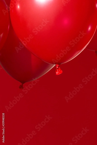 Obraz red helium balloons on red background