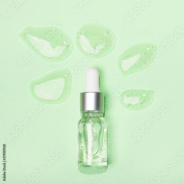Obraz Face serum close-up on the trendy mint background. Collagen, hyaluronic acid for skin care. Achievements of modern science in cosmetic to preserve beauty.