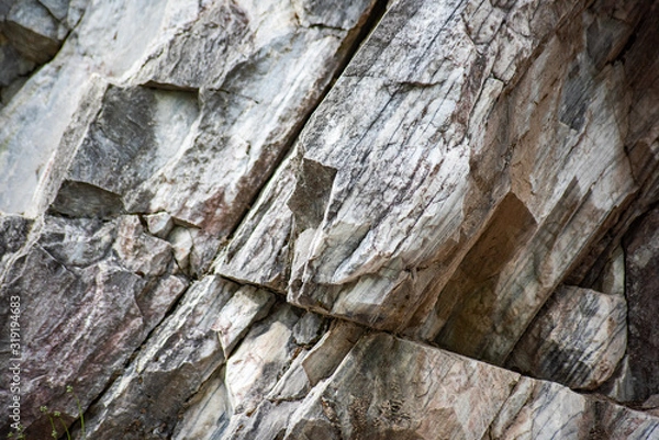 Fototapeta Uneven ledges of marble wall, soft focus