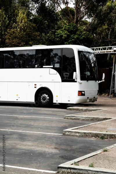 Fototapeta A parking lot with white parked bus