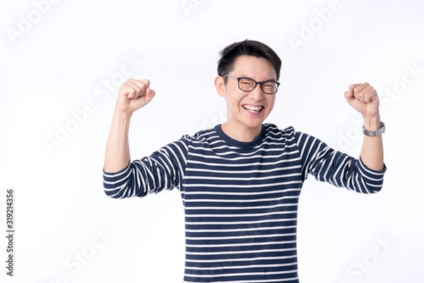 Obraz smart attractive asian glasses male hand rise up cheerful exited standing and smile with freshness and joyful casual blue shirt portrait white background