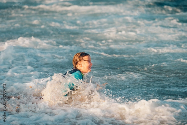 Obraz Funny little boy playing with waves in the sea, family summer vacation with children
