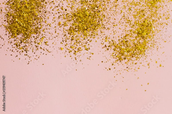 Fototapeta pink background with gold sequins. the concept of a holiday, Valentine's Day, women's day, birthday. place for your text, top view.