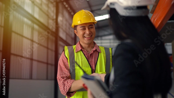 Obraz warehouse workers shaking hand