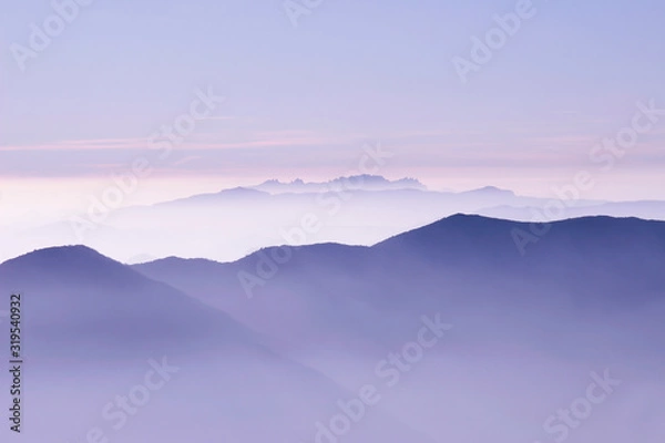 Fototapeta skyline of purple mountains in a misty dawn morning