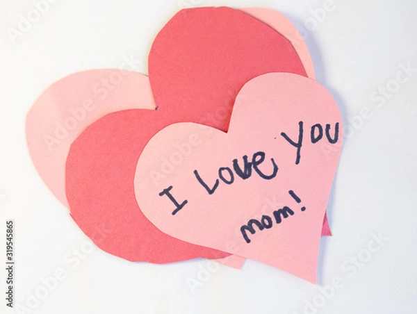Obraz pink, red and white construction paper valentine craft hearts with "I love you" message written by a child