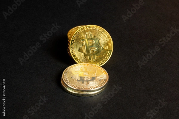 Fototapeta Shiny stack bitcoin coins on black textured background, close up view
