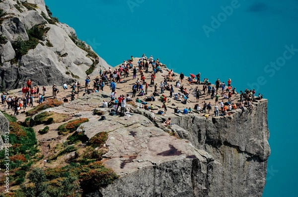 Fototapeta Overcrowded  edge of the cliff Preikestolen in Norway. A tourist attraction in the municipality of Strand in Rogaland.