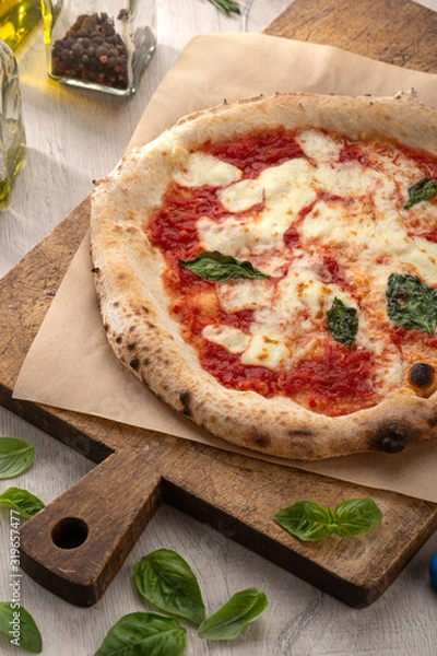 Obraz Delicious fresh pizza on table. Rustic pizza with minced meat cheese, basil on top. pizza with meat and basil. Homemade delicious italian pizza on wooden table for dinner. Italian cuisine.