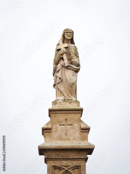 Fototapeta Statue on a waycross in Burgenland with snow