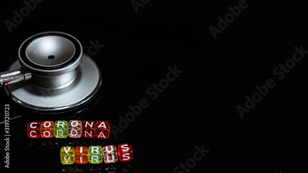 Fototapeta Colorful text "Corona virus" and   Medical stethoscope  put on  Black background. corona virus Concept.