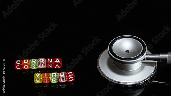 Fototapeta Colorful text "Corona virus" and   Medical stethoscope  put on  Black background. corona virus Concept.