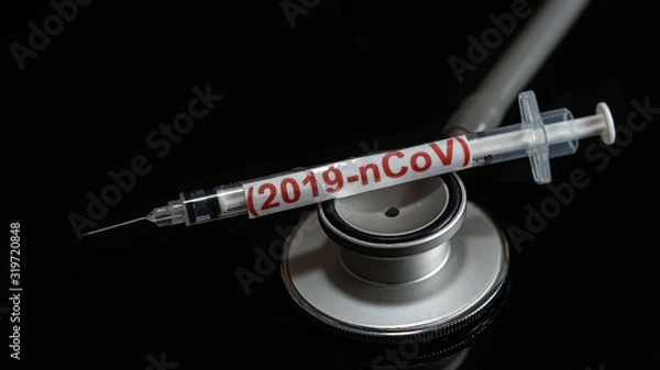 Fototapeta syringe have text "(2019-nCoV)  with Medical stethoscope  put on  Black background. corona virus Concept.