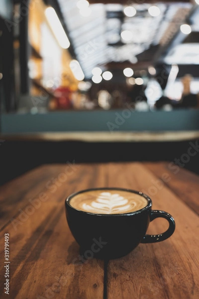 Fototapeta Coffee cup on wooden table bokeh background
