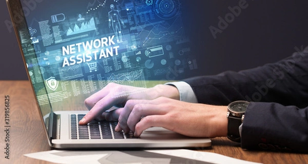 Fototapeta Businessman working on laptop with NETWORK ASSISTANT inscription, cyber technology concept