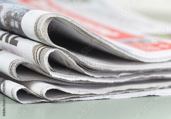 Obraz Pile of folded french newspapers on a table