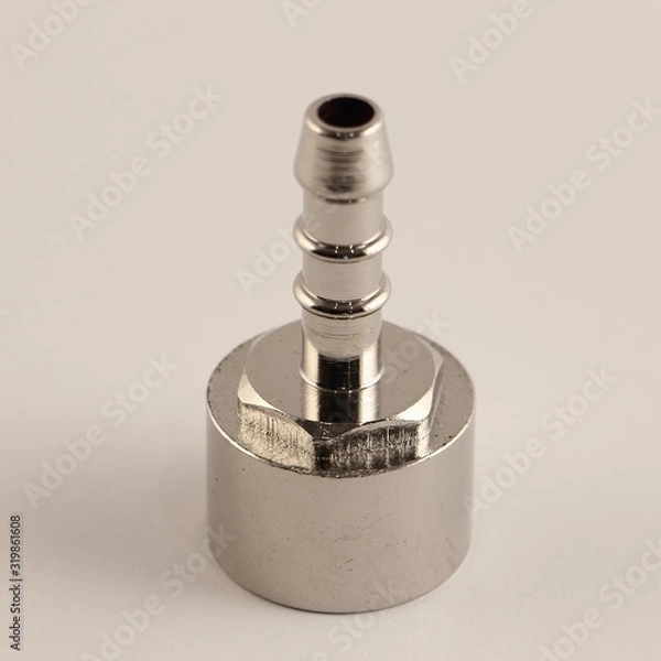 Fototapeta Chrome ribbed connector from 1/2" thread to hose, close up plumbing fixtures on white background
