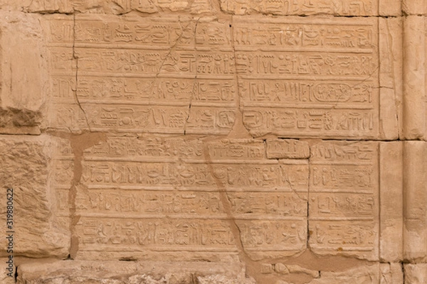 Fototapeta Karnak Temple, complex of Amun-Re. Embossed hieroglyphics on walls. Luxor Governorate, Egypt.