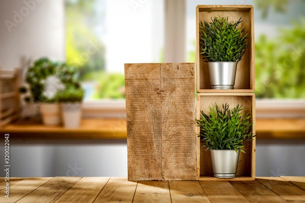 Fototapeta Wooden desk in kitchen interior and blurred spring window space 