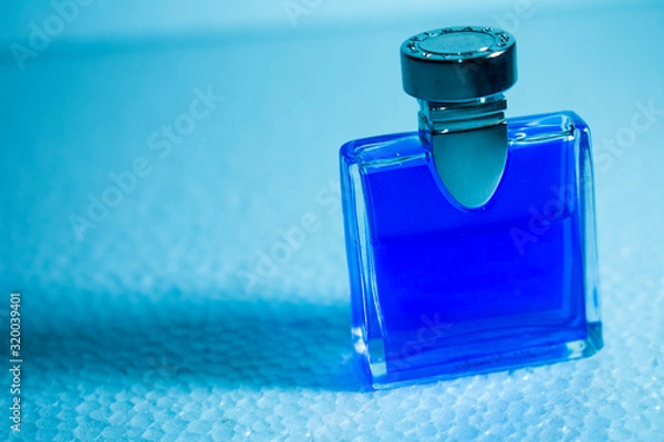 Obraz blue perfume bottle on background