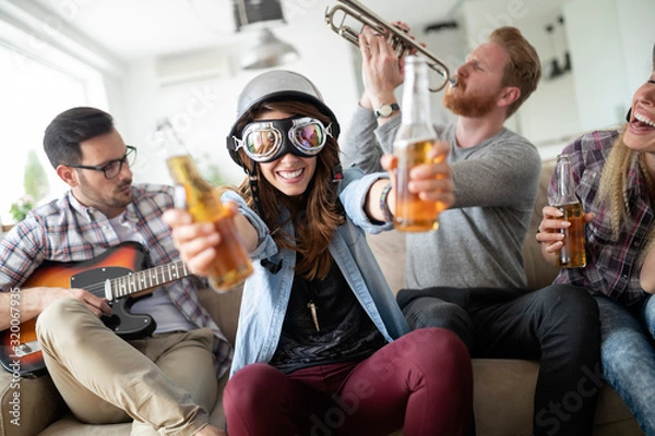 Fototapeta Group of young friends having fun together and playing in music band