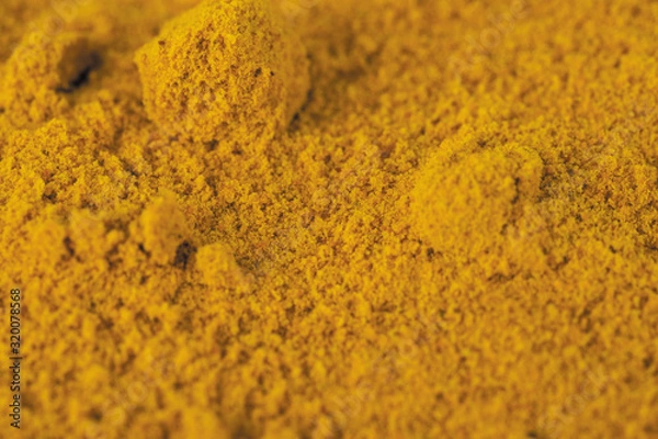 Fototapeta Tumeric yellow spice for curry close-up
