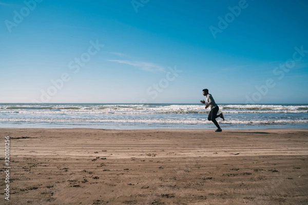 Fototapeta Portrait of an athletic man running.