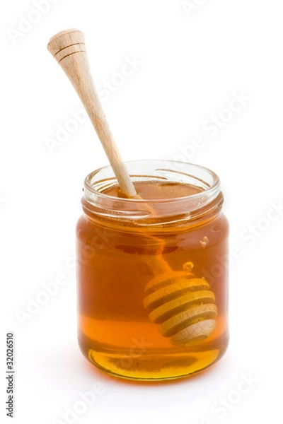 Fototapeta Honey dripper in a jar of honey