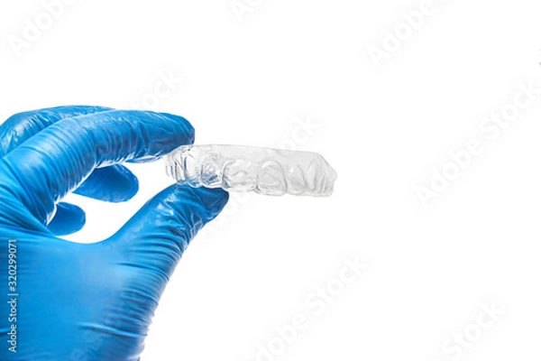 Fototapeta Hand holding individual dental tray for bleaching teeth Isolated on a white background