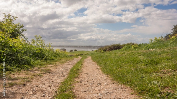Obraz Walking trail at Red Rock, Sutton, County Dublin on the east coast of Ireland. A martello Tower and Dublin Bay can be seen in the distance.