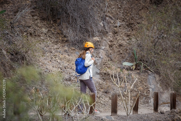 Fototapeta Woman walking on path in ravine of Tenerife