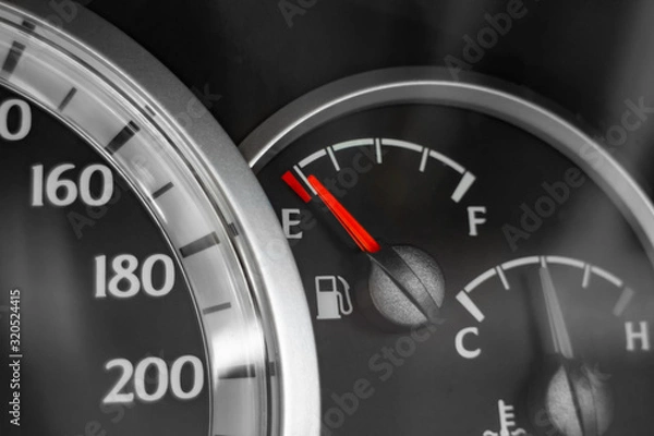 Fototapeta Close-up of car dashboard showing speedometer, fuel indicator and temperature indicator.