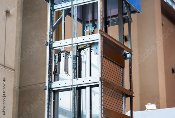 Fototapeta Elevator Installation, Lift Technician Installing a Modern Elevator