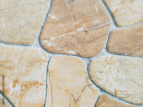 Fototapeta Marble tile looking like stone rocks glued together making an interesting floor design in the home or a cool modern wallpaper