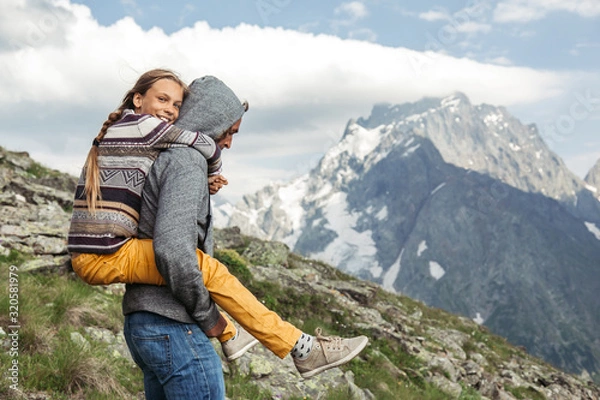 Fototapeta Father with child walking on the mountain and enjoying beautiful view
