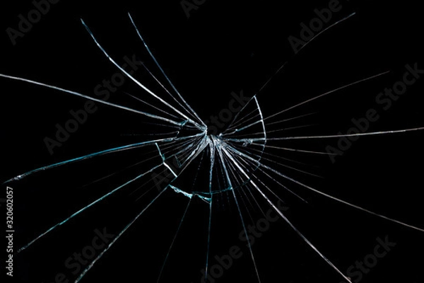 Fototapeta crack on the broken glass mirror on a black background chipped