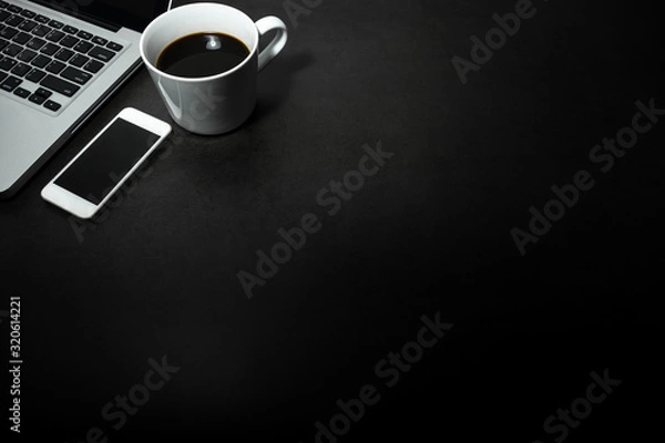 Obraz Laptop, white mobile phone  and a cup of black coffee against empty dark background, working office theme